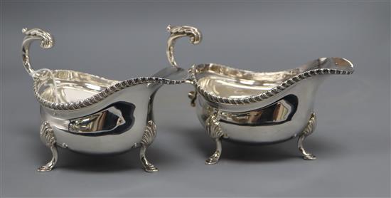 A pair of mid 20th century silver sauceboats, with flying scroll handles, I.S. Freeman & Co, London, 1959, height 11.2cm, 20 oz.